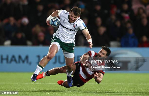 London Irish full back James Stokes breaks the tackle of Gloucester centre Giorgi Kveseladze during the Gallagher Premiership Rugby match between...