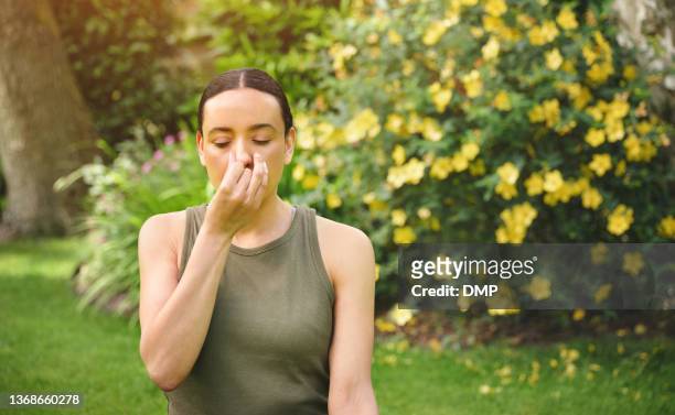shot of a mature woman doing alternate nostril breathing exercises outdoors - covering nose stock pictures, royalty-free photos & images