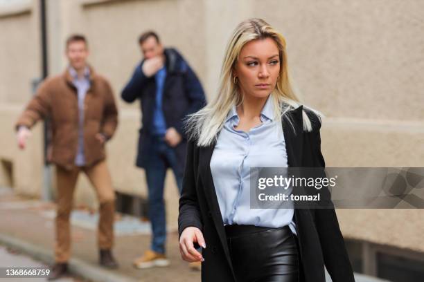 woman getting attention on city street - whistle stock pictures, royalty-free photos & images