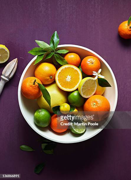 bowl of citrus fruit overhead - fruit bowl stock pictures, royalty-free photos & images