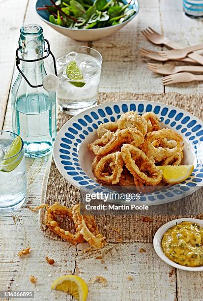 fried squid rings on table - calamares stock-fotos und bilder