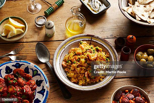 spanish tapas and paella on table - culinary tradition stockfoto's en -beelden