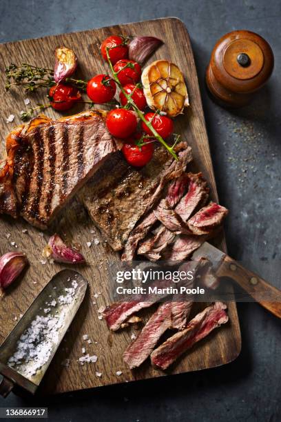 steak cut on board with roasted veg - steek stock pictures, royalty-free photos & images