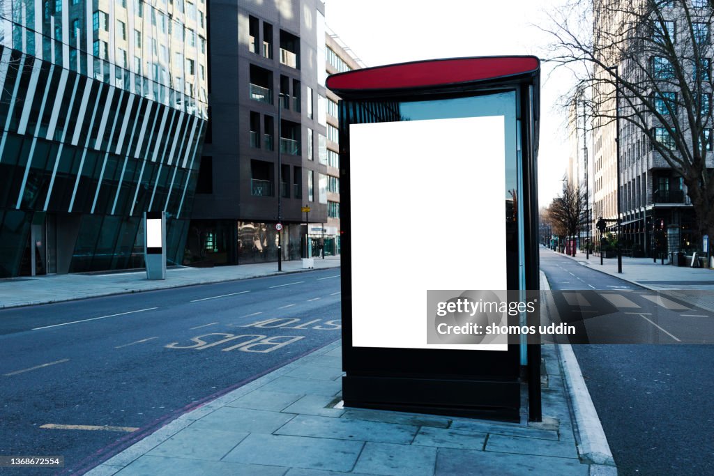 Street of London with blank digital billboard at bus stop