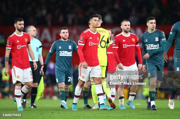 Cristiano Ronaldo, Bruno Fernandes and Luke Shaw of Manchester United leave the pitch after losing the penalty shoot out during the Emirates FA Cup...