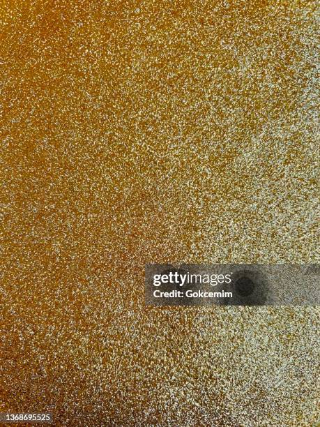 abstract background with golden glittering brush stroke. gold foil shiny grunge texture. - gold patina stock illustrations