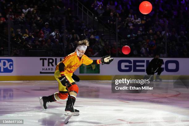 Trevor Zegras of the Anaheim Ducks, dressed as the character Peter La Fleur from the movie "Dodgeball: A True Underdog Story," shoots the puck while...
