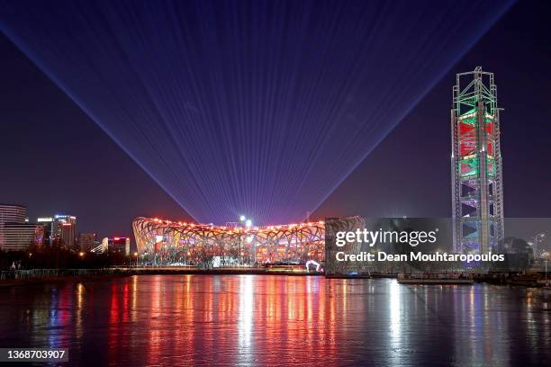 General View outside the National Stadium, also known as the Bird's Nest and Yangshan River as a firework display is seen above the Opening Ceremony...