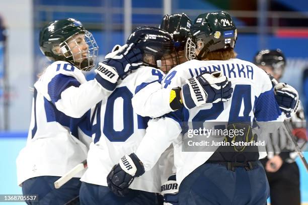 Minnamari Tuominen of Team Finland is congratulated by their teammates after scoring a goal against Team Canada in the first period during the...