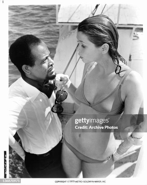 Debebe Eshetu receives instructions from Neda Arneric on how he must get Shaft to her cabin in a scene from the film 'Shaft In Africa', 1973.