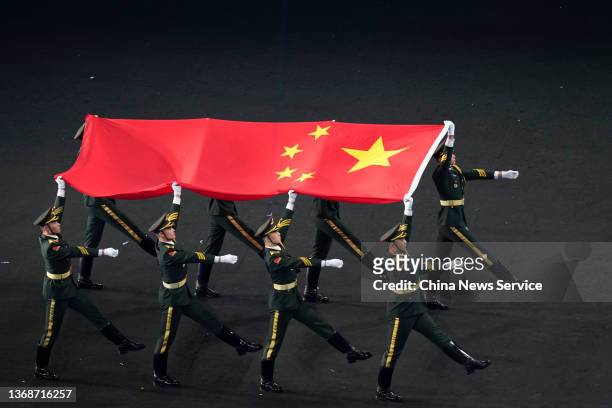 Chinese national flag is carried during the Opening Ceremony of the Beijing 2022 Winter Olympics at the Beijing National Stadium on February 4, 2022...