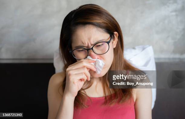 close up of young asian woman sneezing in tissue cause of cold and flu. - asian waiting angry expressions stock pictures, royalty-free photos & images