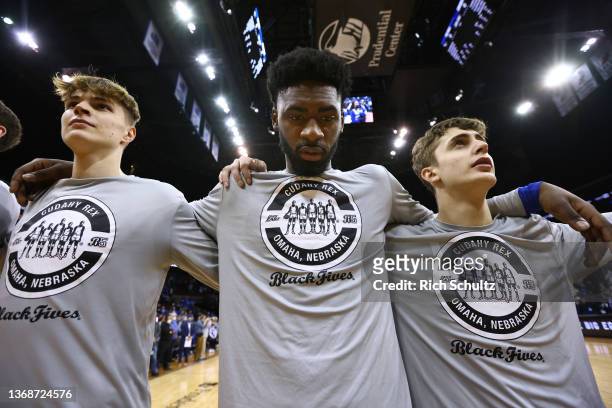 Zander Yates, KeyShawn Feazell and Sami Osmani of the Creighton Bluejays and their teammates wear shirts honoring the Cudahy Rex of the Black Fives...