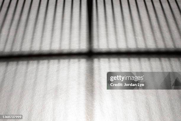 shadow on tiled floor - prison wall stock pictures, royalty-free photos & images