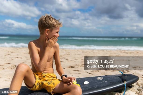 almost ready to surf, sun safety first - board shorts stock pictures, royalty-free photos & images