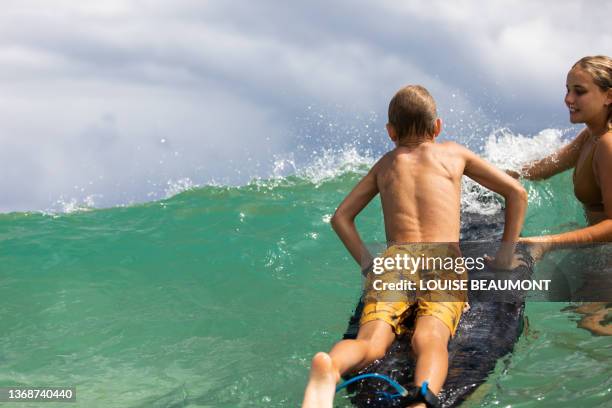 learning to surf - high color image stock pictures, royalty-free photos & images