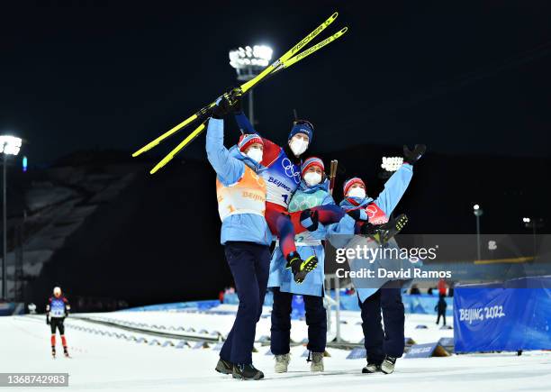 Tarjei Boe, Johannes Thingnes Boe, Tiril Eckhoff and Marte Olsbu Roeiseland of Team Norway celebrate after winning the Biathlon Mixed Relay 4x6km...