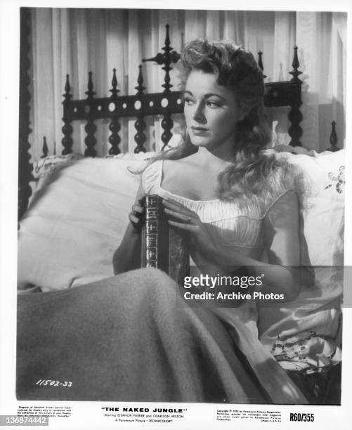Eleanor Parker in bed with a book in a scene from the film 'The Naked Jungle', 1953.