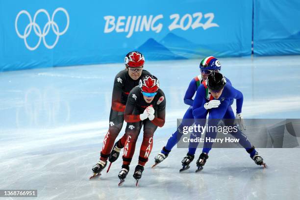 Kim Boutin of Team Canada gets a push from teammate Courtney Sarault as they compete with Arianna Fontana and Martina Valcepina of Team Italy during...