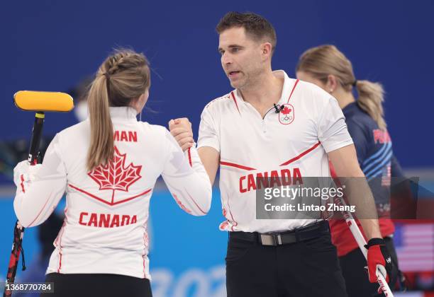 John Morris and Rachel Homan of Team Canada celebrate victory against Team United States during the Curling Mixed Doubles Round Robin on Day 1 of the...
