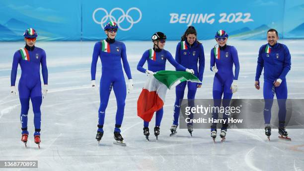 Team Italy celebrate winning the Silver medal during the Mixed Team Relay Final A on day one of the Beijing 2022 Winter Olympic Games at Capital...