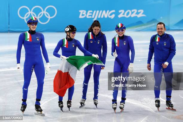 Team Italy celebrate winning the Silver medal during the Mixed Team Relay Final A on day one of the Beijing 2022 Winter Olympic Games at Capital...