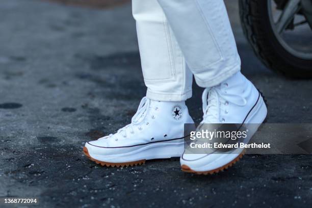 A guest wears white denim jeans pants, white Run Away ankle sneakers...  News Photo - Getty Images