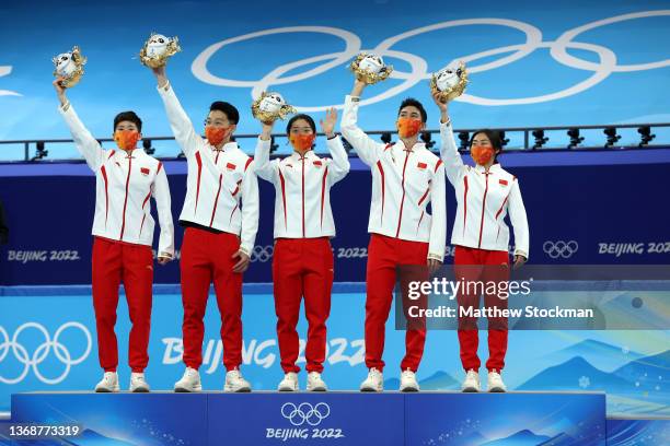 Gold medallists Team China pose during the Mixed Team Relay Final flower ceremony after the Mixed Team Relay Final A on day one of the Beijing 2022...