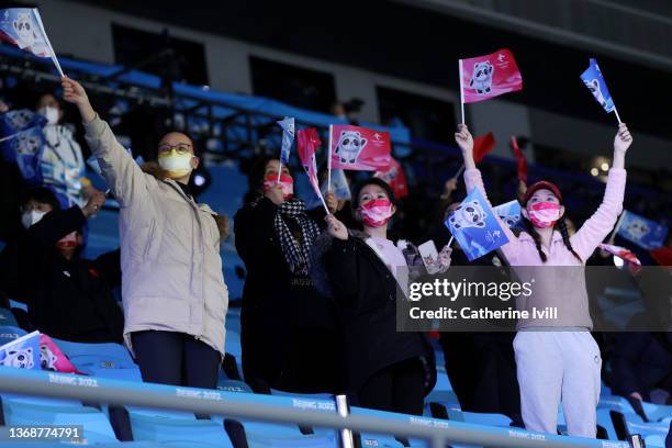 Spectators celebrate during the Mixed Team Relay Final A on day one of the Beijing 2022 Winter Olympic Games at Capital Indoor Stadium on February...