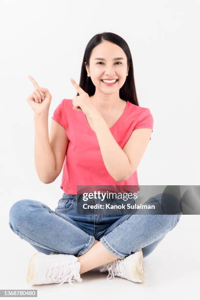 beautiful woman pointing at the side - full length photos stock pictures, royalty-free photos & images