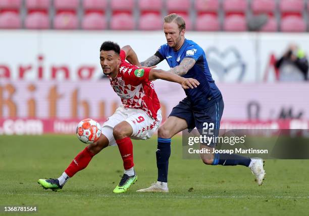 Karim Onisiwo of 1. FSV Mainz 05 challenges Kevin Vogt of TSG Hoffenheim during the Bundesliga match between 1. FSV Mainz 05 and TSG Hoffenheim at...