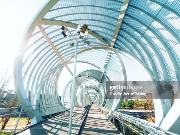 modern bridge design with tube shape in madrid. - digital catwalk stock pictures, royalty-free photos & images