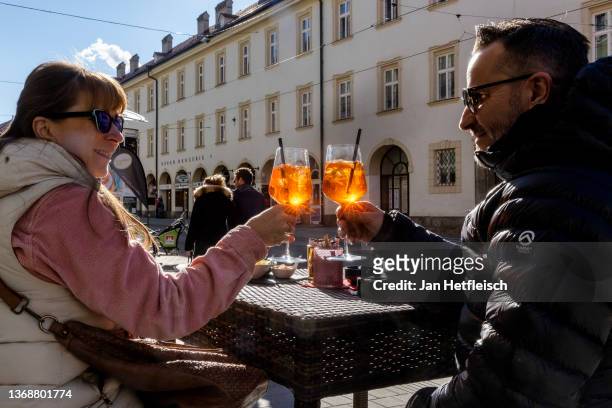 Cafe guests toast their drinks on February 05, 2022 in Innsbruck, Austria. Austria is phasing in a nationwide vaccination mandate against Covid-19 in...