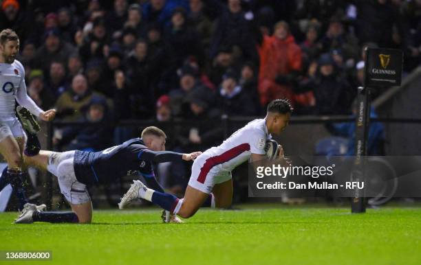 Marcus Smith of England beats Finn Russell of Scotland to score his sides first try during the Guinness Six Nations match between Scotland and...
