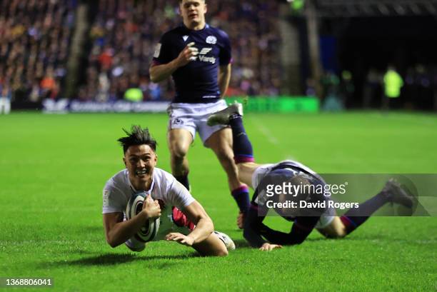 Marcus Smith of England beats Finn Russell of Scotland to score his sides first try during the Guinness Six Nations match between Scotland and...