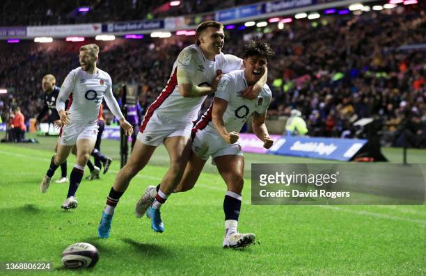 Marcus Smith of England celebrates with Henry Slade after scoring his sides first try during the Guinness Six Nations match between Scotland and...