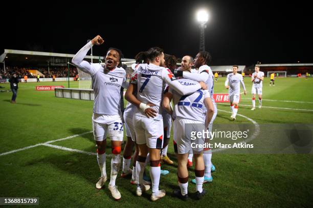 Gabriel Osho of Luton Town celebrates their side's third goal scored by Admiral Muskwe of Luton Town during the Emirates FA Cup Fourth Round match...