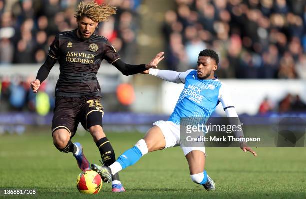 Bali Mumba of Peterborough United tackles Dion Sanderson of Queens Park Rangers during the Emirates FA Cup Fourth Round match between Peterborough...
