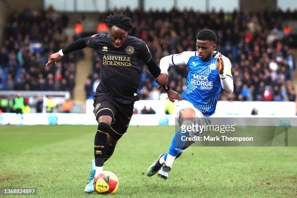 Bali Mumba of Peterborough United challenges Moses Obubajo of Queens Park Rangers during the Emirates FA Cup Fourth Round match between Peterborough...