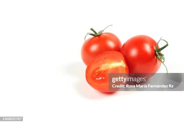 three fresh cherry tomatoes against a white background - tomate cerise photos et images de collection