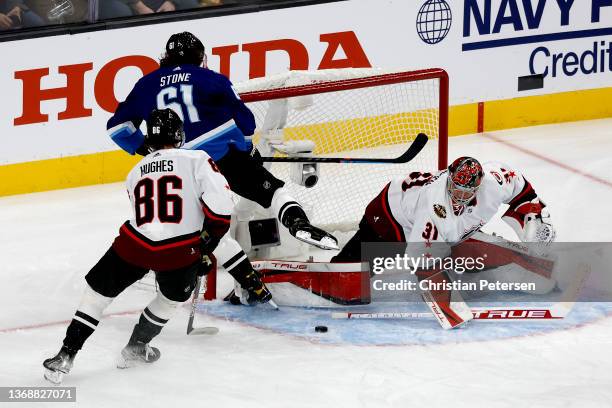 Mark Stone of the Vegas Golden Knights makes a shot on goal against Frederik Andersen of the Carolina Hurricanes as Jack Hughes of the New Jersey...