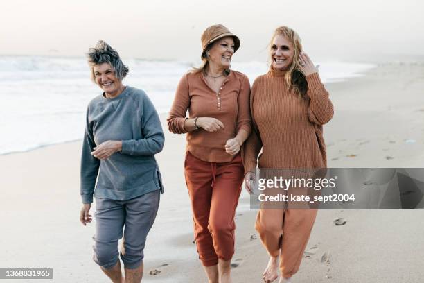 a day at the beach is ideal for active seniors - female friendship stock pictures, royalty-free photos & images