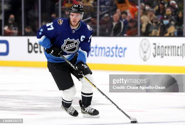 Connor McDavid of the Edmonton Oilers of the Pacific Division skates with the puck during the 2022 NHL All-Star game between the Pacific Division and...