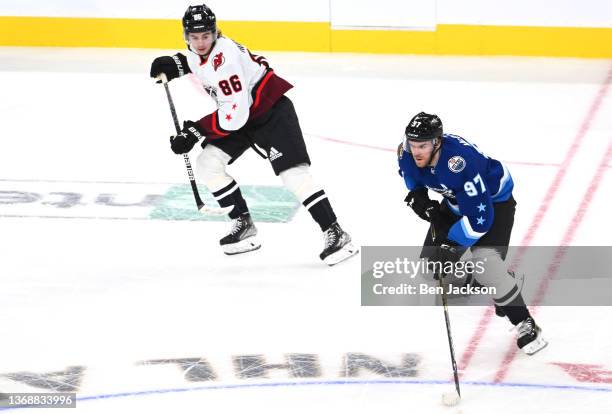 Jack Hughes of the New Jersey Devils of the Metropolitan Division skates with Connor McDavid of the Edmonton Oilers of the Pacific Division during...