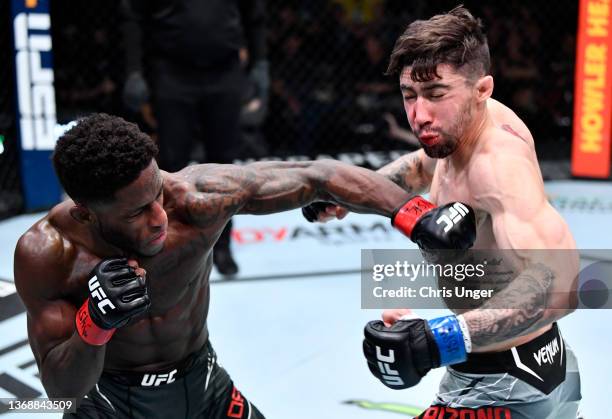 Hakeem Dawodu of Canada punches Michael Trizano in their featherweight fight during the UFC Fight Night event at UFC APEX on February 05, 2022 in Las...