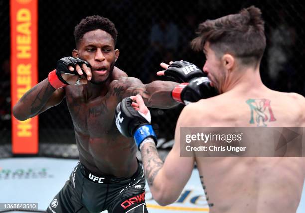 Hakeem Dawodu of Canada punches Michael Trizano in their featherweight fight during the UFC Fight Night event at UFC APEX on February 05, 2022 in Las...