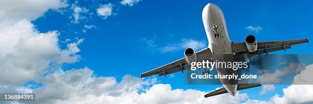 jet airplane landing in cloudy sky - air cargo airplane stock pictures, royalty-free photos & images