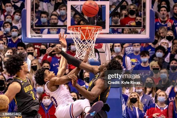 Jonathan Tchamwa Tchatchoua of the Baylor Bears knocks the ball away from Ochai Agbaji of the Kansas Jayhawks in the second half at Allen Fieldhouse...