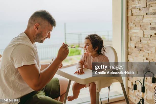 snack for my baby girl - high chair stock pictures, royalty-free photos & images