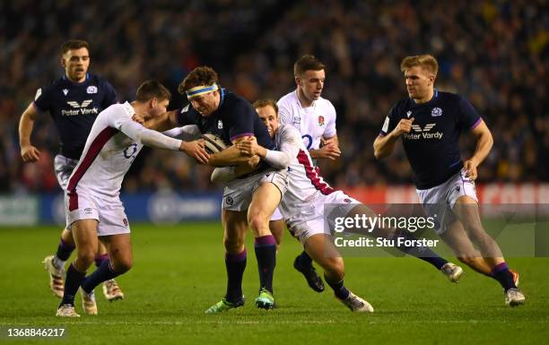 Scotland player Hamish Watson breaks the tackle of Ben Youngs and Max Malins during the Guinness 6 Nations match between Scotland and England at BT...
